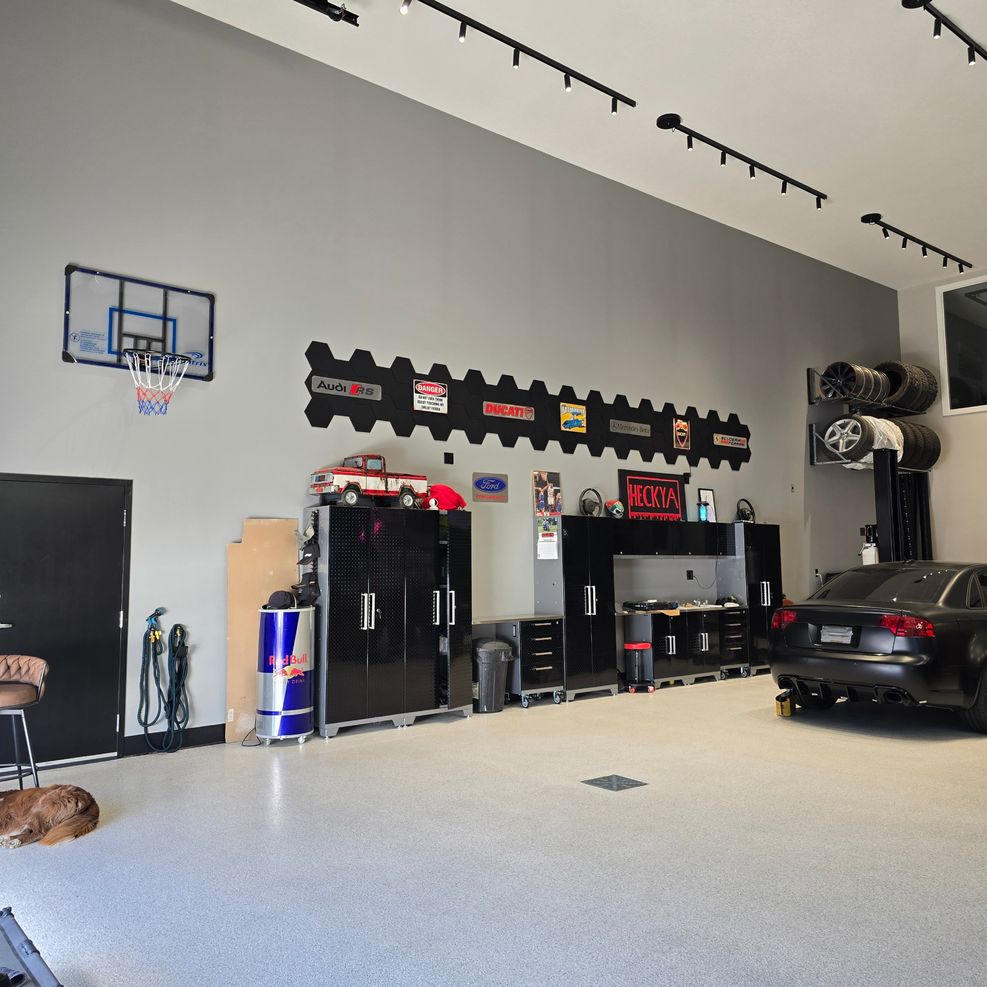 Workbench area with tool cabinets, tire rack, and matte black Audi RS4